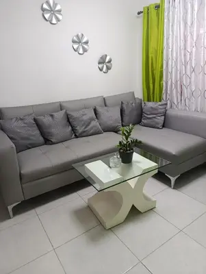 a living room with a couch and a table at Comfort, safety and close to everything in Los Paredones
