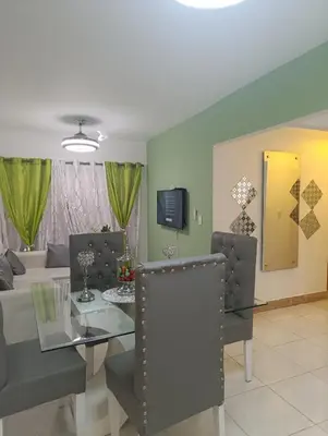 a dining room and living room with a glass table at Comfort, safety and close to everything in Los Paredones