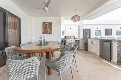 a kitchen and dining room with a table and chairs at Privacy, Big, Exclusive in Sosúa in Sosúa