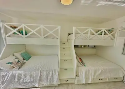 two bunk beds in a white room with twounks at Emmanuel villas luxury in Puerto Plata