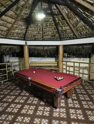 a red pool table in a room with a ceiling at Emmanuel villas luxury in Puerto Plata