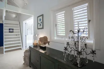 a room with a dresser in a room with windows at Mahona Boutique Hotel in Las Terrenas