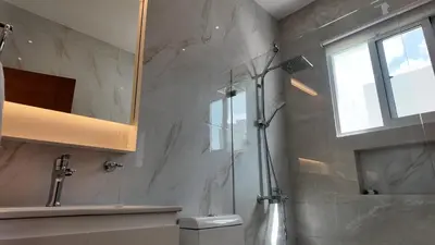 a bathroom with a shower and a toilet and a window at Beach House With Private Pool in Las Terrenas
