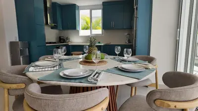 a dining room with a table with chairs and a tableablish at Beach House With Private Pool in Las Terrenas
