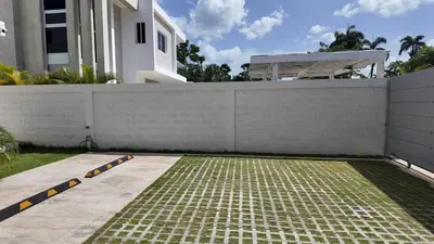 a fence in front of a house with a sidewalk at Beach House With Private Pool in Las Terrenas