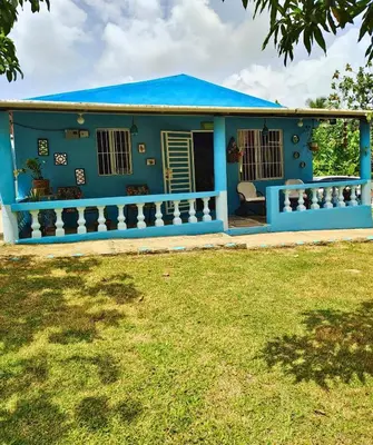 a blue house with a blue roof at Country house with Jacuzzi and BBQ