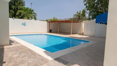 a swimming pool in a yard next to a building at Vista Azul Boca Chica Accommodation in El Higo