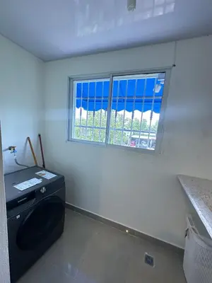 a laundry room with a washing machine and a window at Vista Azul Boca Chica Accommodation in El Higo
