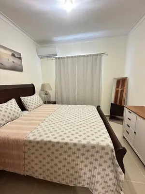 a bedroom with a bed and a dresser and a window at Vista Azul Boca Chica Accommodation in El Higo