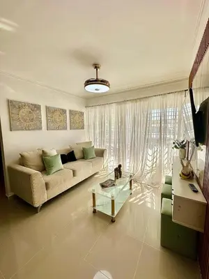 a living room with a couch and a table at Modern, Elegant & Comfortable Apartment in El Seis