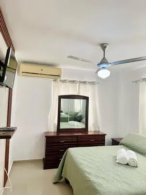 a bedroom with a bed and a ceiling fan at Modern, Elegant & Comfortable Apartment in El Seis