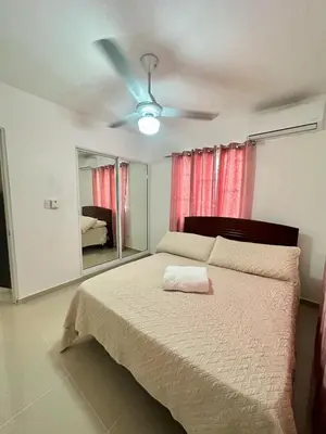 a bedroom with a bed with a ceiling fan at Modern, Elegant & Comfortable Apartment in El Seis