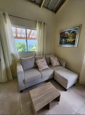 a living room with a couch and a coffee table at Villa Janel in Punta Rucia