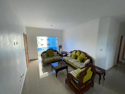 a living room with two couches and a table at Comodo apartamento en Boca Chica SDQ AILA in El Higo