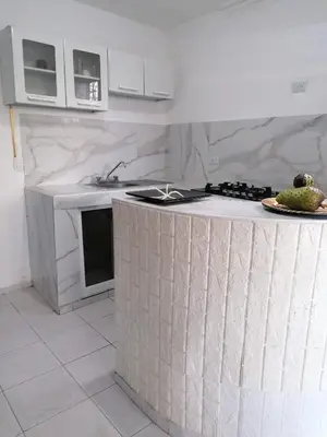 a white kitchen with a counter with a sink at Studio Apartment 5 - SML Garden in La Romana