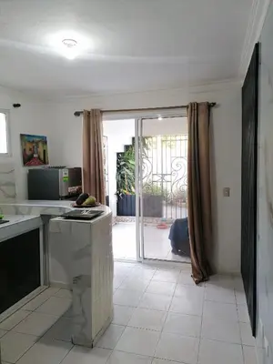 a kitchen with a sliding glass door to a patio at Studio Apartment 5 - SML Garden in La Romana