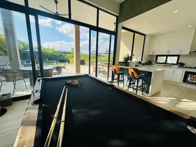 a pool table in the middle of a living room at Villa Aguacate Near the Beach in Juan Dolio