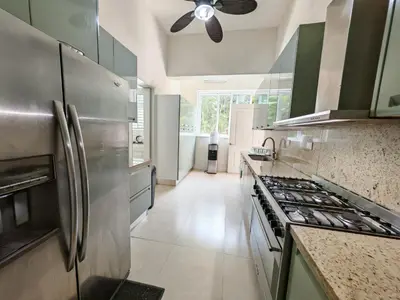 a kitchen with stainless steel appliances and a ceiling fan at Casa de Campo Luxury Villa with private Pool & Jacuzzi, Near Beach, Marina, Golf, Restaurants & Altos de Chavon in La Romana