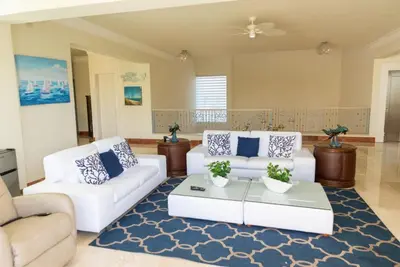 a living room with two white couches and a blue rug at Casa de Campo Luxury Villa with private Pool & Jacuzzi, Near Beach, Marina, Golf, Restaurants & Altos de Chavon in La Romana