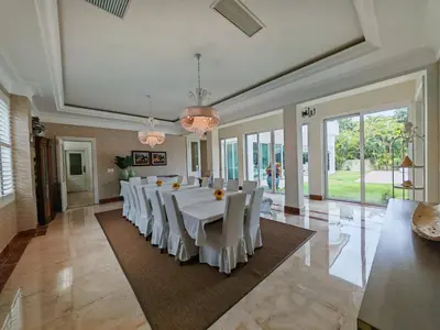 a large dining room with a long table with white chairs at Casa de Campo Luxury Villa with private Pool & Jacuzzi, Near Beach, Marina, Golf, Restaurants & Altos de Chavon in La Romana