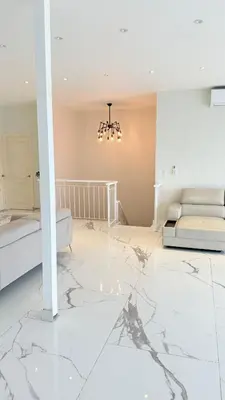 a living room with two beds and a marble floor at SoHo Loft Penthouse in Santo Domingo