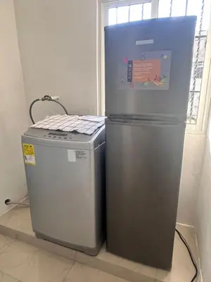 two refrigerators sitting next to each other in a room at Comodo y acogedor apartamento en Los Mameyes in Los Tres Ojos de Agua