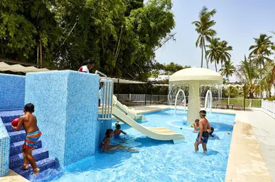 a group of people in a pool at a water park at Riu Palace Punta Cana - All Inclusive in Punta Cana
