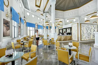 a rendering of a restaurant with yellow chairs and tables at Riu Palace Punta Cana - All Inclusive in Punta Cana