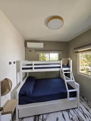 a bedroom with a bunk bed with a blue pillow at Rest in Paradise, Pool, Beach and Terrace in Sánchez