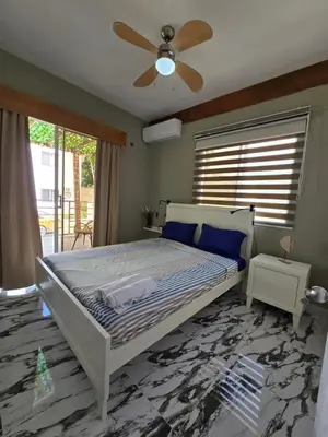 a bedroom with a bed and a ceiling fan at Rest in Paradise, Pool, Beach and Terrace in Sánchez