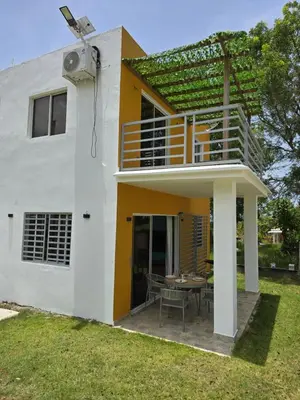 a house with a balcony and a table in the yard at Rest in Paradise, Pool, Beach and Terrace in Sánchez