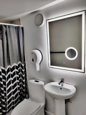 a bathroom with a sink and a toilet and a mirror at Hostel capicua in Punta Cana