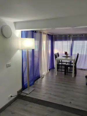 a dining room with a white table and chairs at Hostel capicua in Punta Cana