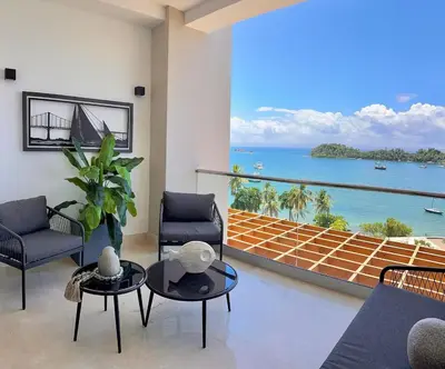 a living room with a view of the ocean at Stylish Studio Samaná Bay View, Pool and Gym Access in Santa Bárbara de Samaná