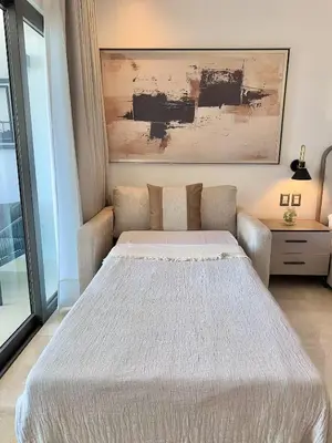 a bedroom with a bed and a couch at Stylish Studio Samaná Bay View, Pool and Gym Access in Santa Bárbara de Samaná