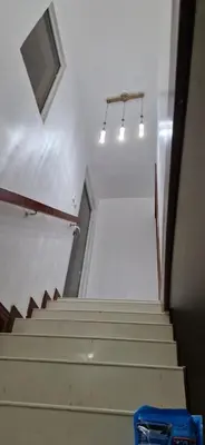 a set of stairs in a building with lights at Casa Perez CCC in Juan Dolio
