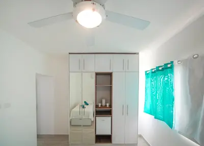 a bathroom with a white cabinet and a light at Le Camere Del Maestro in Bayahibe