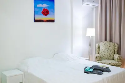 a hotel room with a bed and a chair at Art Villa Dominicana in Punta Cana