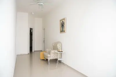 a white room with a chair and a table at Art Villa Dominicana in Punta Cana