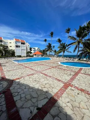a resort with two swimming pools and palm trees at Vista palmera in Juan Pedro