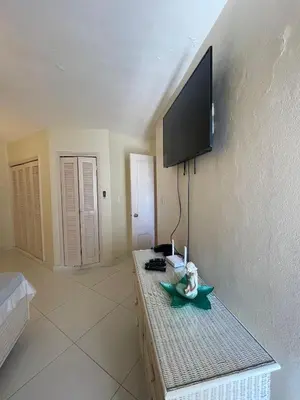 a living room with a flat screen tv on a wall at Vista palmera in Juan Pedro