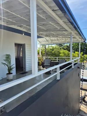 an outdoor deck with a pergola on a house at OMY Apartments Nagua 2A in Nagua