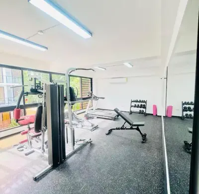 a gym with treadmills and chairs in a room at Beachfront apartment Sunset in Colorado