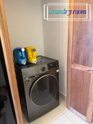 a washing machine with two toys on top of it at Beachfront apartment Sunset in Colorado