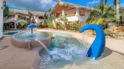 a water slide in the middle of a pool at Guest-Room 1 Palmeras - 3 Pax, 5 Min de La Playa in Las Galeras