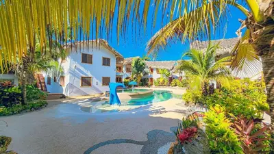 a house with a swimming pool and palm trees at Guest-Room 1 Palmeras - 3 Pax, 5 Min de La Playa in Las Galeras