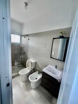 a bathroom with a toilet and a sink and a mirror at Greta's Penthouse Bayahibe in Bayahibe