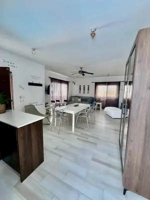 a large room with tables and a bed in it at Greta's Penthouse Bayahibe in Bayahibe