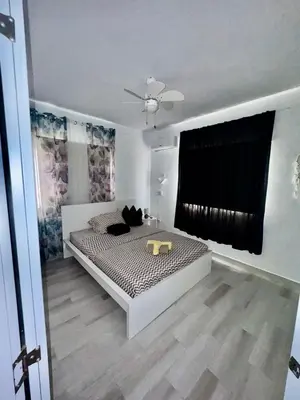 a bedroom with a bed and a ceiling fan at Greta's Penthouse Bayahibe in Bayahibe