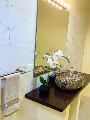 a bathroom with two sinks and a large mirror at Villa KAMBUSA appartamento SOFIA in Las Galeras
